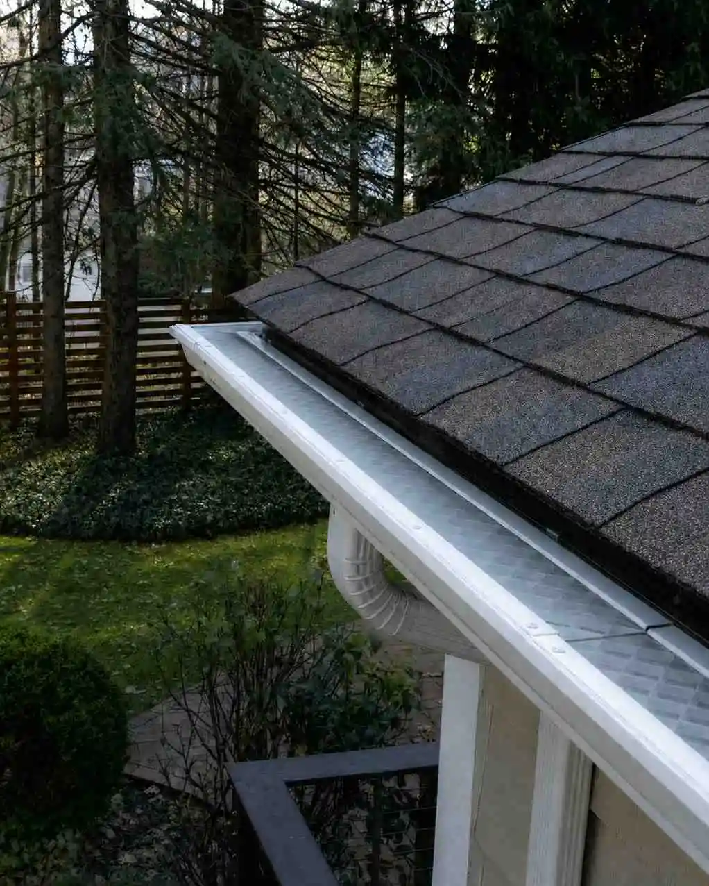 Protective gutter guard installed over a residential rain gutter
